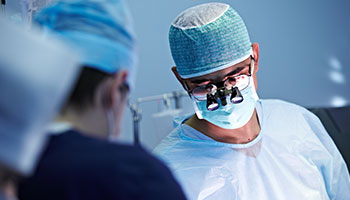 A surgeon performing surgery in an operating room